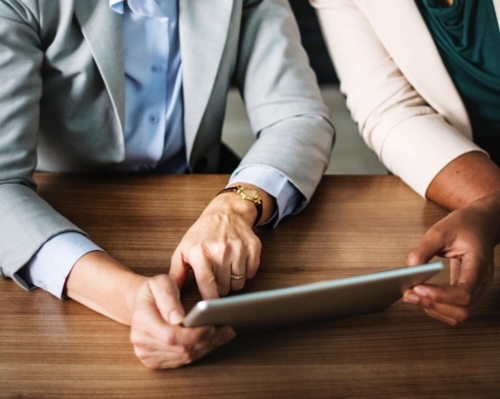 business people looking at tablet