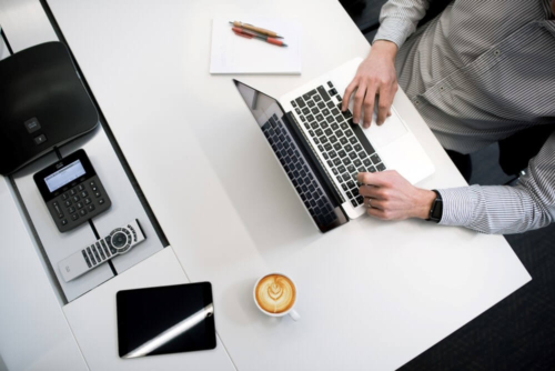 business person typing on computer